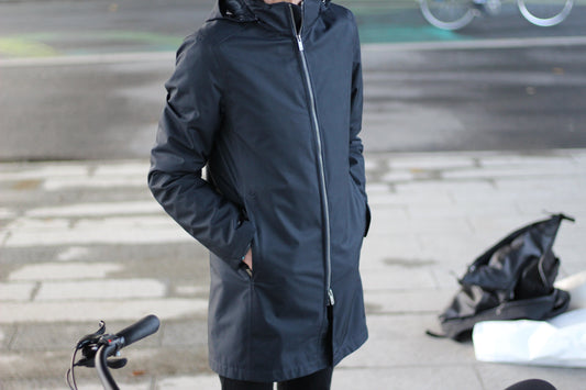 Veste moto discrète VEST PARIS, design urbain chic avec protection invisible CE, portée par un cadre citadin en scooter, imperméable et adaptée aux déplacements professionnels.